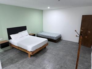 a bedroom with a white bed and a bed sidx sidx sidx at Softi Sur in Comodoro Rivadavia