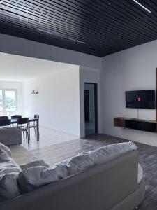 a living room with a couch and a television on the wall at Softi Sur in Comodoro Rivadavia