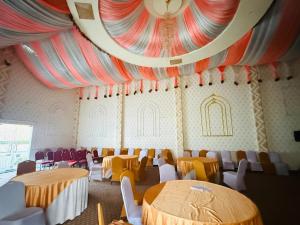 a room with tables and chairs and a ceiling at RJ Hotel Pokhara in Pokhara +32 photos
