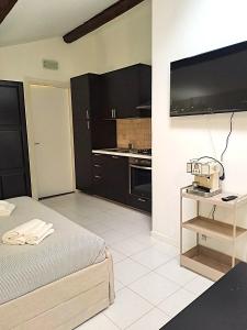 a large room with a bed and a kitchen at Residence Borghesi in Parma