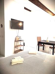 a bedroom with a bed with a table and a television at Residence Borghesi in Parma