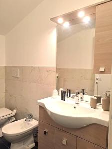a bathroom with a sink and a toilet and a mirror at Residence Borghesi in Parma