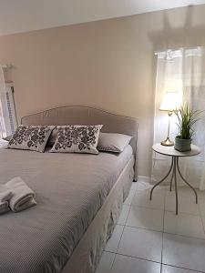 a bedroom with a bed and a table with a lamp at Residence Borghesi in Parma