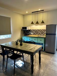 a kitchen with a wooden table and a refrigerator at LÁZARO D primer piso in Monterrey