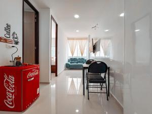 a coca cola refrigerator in a living room with a cocacola at Fee4Me Flat near Neomundo in Bucaramanga