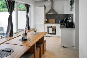 a kitchen with a table with a bottle of wine at Barbat Home-Ferienwohnung im Alexanderstraße in Hamburg