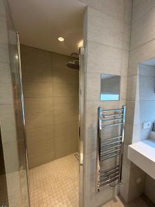 a shower with a glass door in a bathroom at Le Clos du XVIe - Exceptional accommodation in Orléans