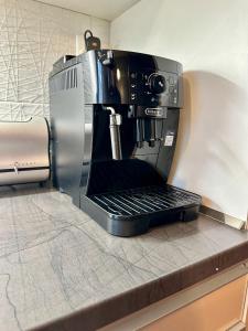 a coffee maker sitting on top of a counter at Unique main square apartment - AC - Balcony - Coffee Machine - Washer - Kitchen- Parking available Free public or Paid Private for 20 euro per stay Please read our emails in Poprad