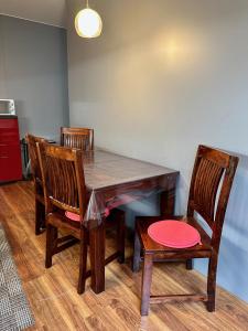 a dining room table with chairs and a red plate on it at Unique main square apartment - AC - Balcony - Coffee Machine - Washer - Kitchen- Parking available Free public or Paid Private for 20 euro per stay Please read our emails in Poprad