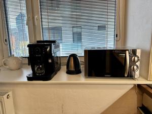 a microwave sitting on a counter in a kitchen at Home Away main square apartment - sleeps 6 - AC - Balcony - Coffee Machine - Washer - Kitchen - Parking in Poprad