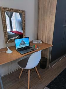 a laptop computer sitting on a desk with a chair at The Converted Space in Welkom +21 photos