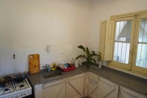 a kitchen with a sink and a stove and a window at Quinta San Miguel in Concordia