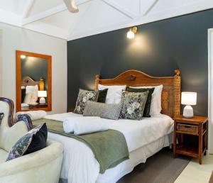 a bedroom with two beds and a mirror at Five Mountains Guest Farm & Spa in Wellington +71 photos