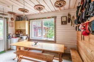 a kitchen with a wooden table and a bench at Provincija in Palanga