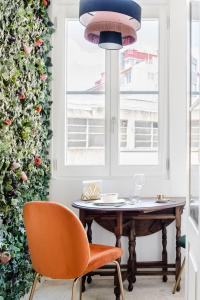 a dining room with a table and two chairs at Get a Golden and Flower Flat in Porto +17 photos