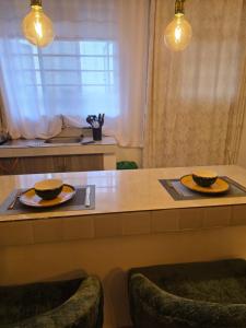a table with two plates and two bowls on it at Misty Cabins in Ruringʼu