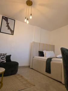a bedroom with a large bed and a chair at Misty Cabins in Ruringʼu