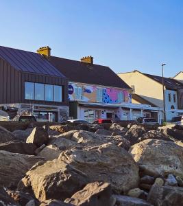 a large group of rocks in front of a building at Beachfront Apartments in Sligo
