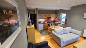 a kitchen with a couch and a table in a room at Beachfront Apartments in Sligo +17 photos
