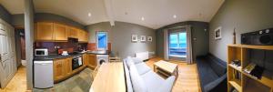 a large kitchen with a couch and a table at Beachfront Apartments in Sligo