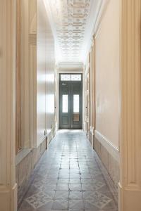 an empty hallway with a door and a tile floor at Get a Unique and Luxury Flat in Porto