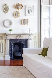 a living room with a white couch and a fireplace at Get a Unique and Luxury Flat in Porto