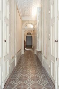 an empty hallway with a tile floor in a building at Get a Unique and Luxury Flat in Porto