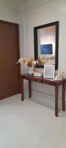 a table with a mirror and a laptop on it at JB Casa del Alivio in Butuan +2 photos