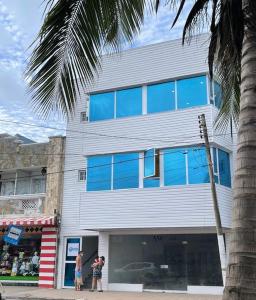 a group of people standing outside of a building at Borabora Hotel in San Andrés
