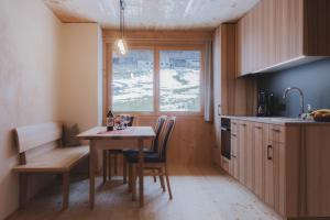 a kitchen with a table and chairs and a window at Ferienwohnung Flatz in Egg