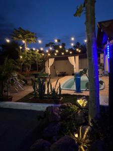 a swimming pool in a yard at night at Pousada Buganvília in Tianguá