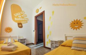 a bedroom with two beds and a surfboard on the wall at Fontana Oasis Apartment in Castelnuovo del Garda
