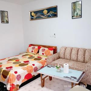 a living room with a bed and a couch at Les studios meublés d'Angré in Abidjan
