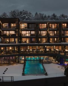 an apartment building with a swimming pool at night at Chalet Mirabell in Avelengo