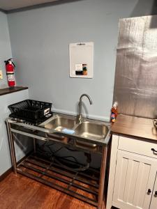 a kitchen with a sink and a stove at MidwestBNB Room1, quite cabin in the wood vibes in Minneapolis