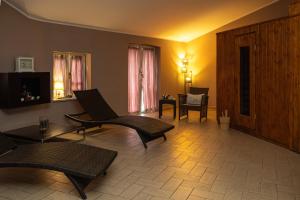 a living room with two chairs and a table at Hotel Valentino in Acqui Terme