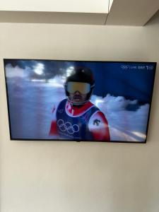 a flat screen tv hanging on a wall at Ferienhaus Mützenzauber in Filzmoos