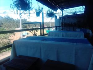 a group of white tables in a room with a window at Ambewela Pattipola snowflak rest in Nuwara Eliya