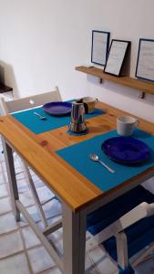 a wooden table with a blue placemat on it at la scogliera in Vernazza