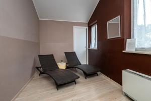 two chairs and a table in a room at Hotel Valentino in Acqui Terme +31 photos
