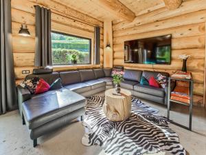 a living room with a couch and a table at Ferienblockhaus Schwarzwald - Luxus Chalet mit Sauna & Whirlpool in Feldberg