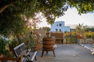 a garden with a chair and a bench and a building at Matina's Family in Mikri Vigla +17 photos