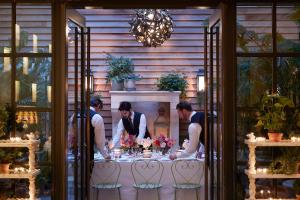 a group of people standing at a table with flowers at The Whitby Hotel in New York