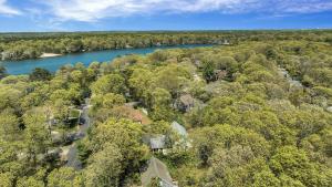 an aerial view of a river and trees at Jenkins Pond Beach Access with BBall Hoop & Grill, Bright Cape Cod Retreat near Jenkins Pond in Falmouth - Parking, Modern Retreat with Outdoor Space, 24 Hour Hospitality in Falmouth