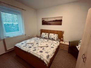 a bedroom with a bed with two towels on it at Penzion Amálka in Třeboň