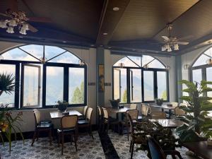 a restaurant with tables and chairs and windows at Sapa Landscape Homestay in Sapa +20 photos