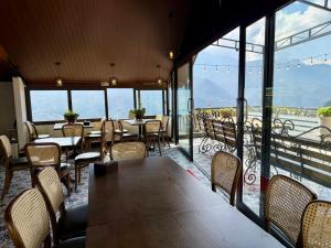 a dining room with tables and chairs and a balcony at Sapa Landscape Homestay in Sapa