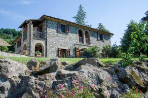 a stone house with rocks in front of it at Agriturismo Tenuta Lapone in Orvieto