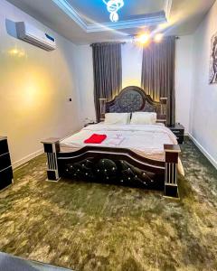 a bedroom with a large bed in a room at Premium Luxury Apartments in Abuja