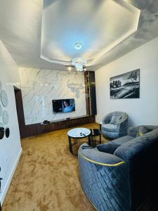 a living room with a couch and a table at Premium Luxury Apartments in Abuja